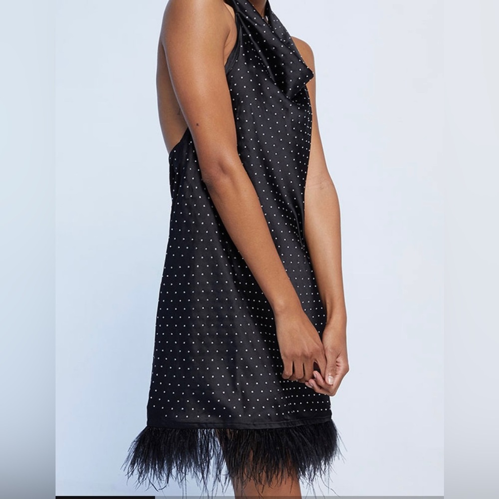 We Wore What halter mini black satin dress with feathered hem and rhinestones.